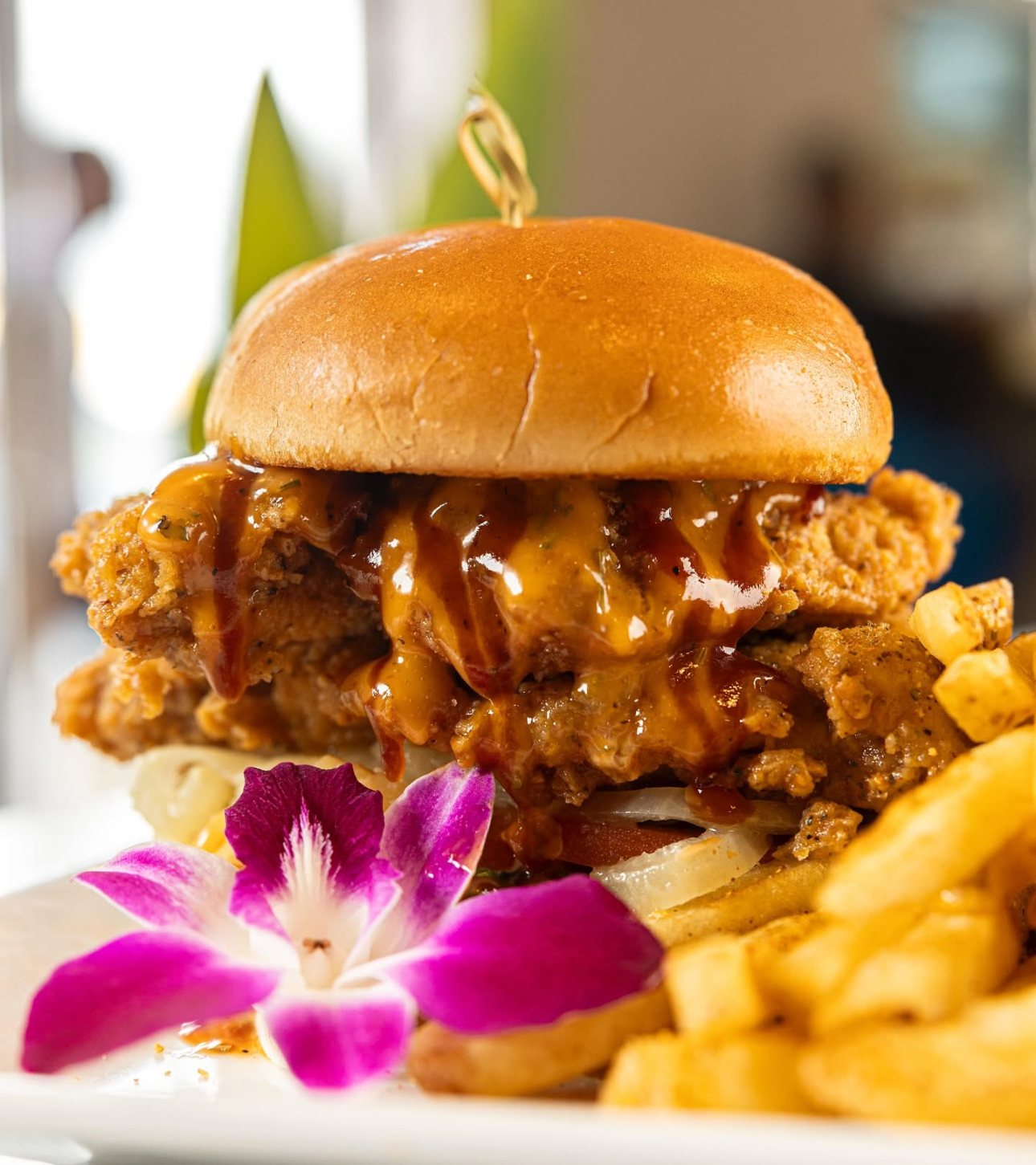 Hot Honey Chicken Burger with French fries at Harvest Cafe Nassau